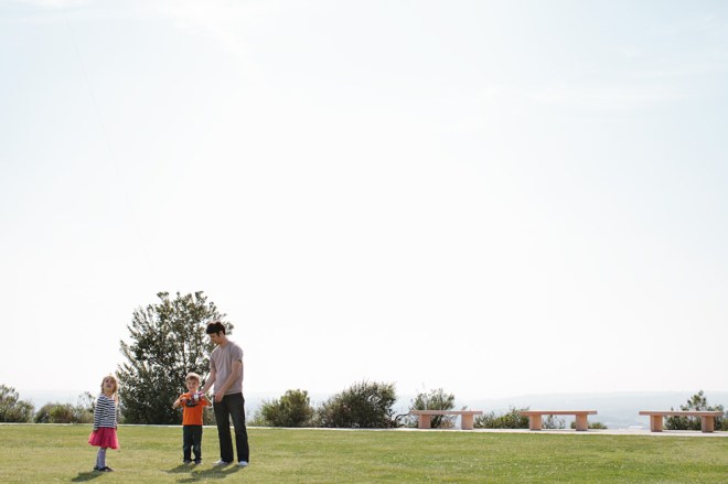 Flying a kite with the kids on a sunny Sunday afternoon