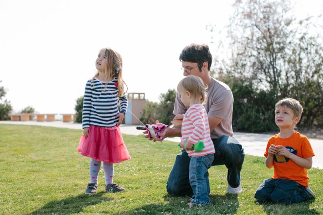 Flying a kite with the kids on a sunny Sunday afternoon